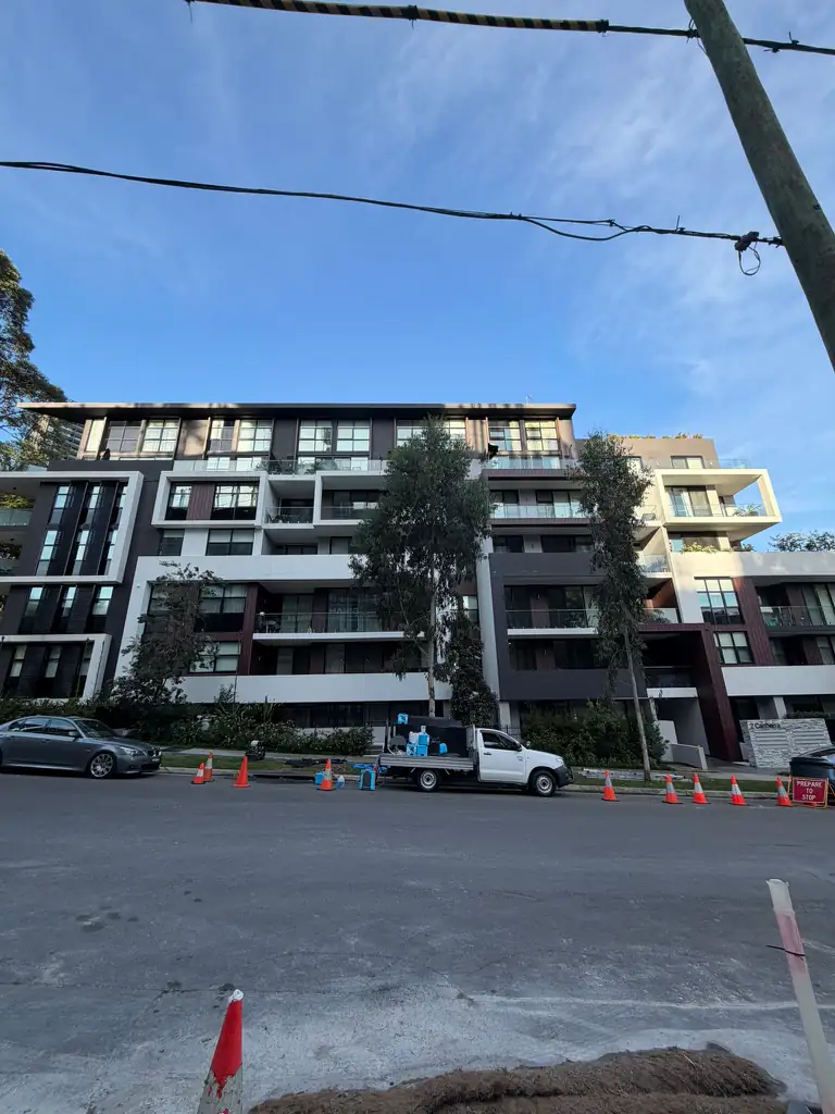 Clean Haven's ute and traffic cones set up outside an apartment building before a job