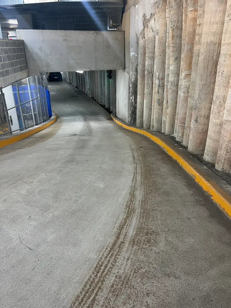 Curved basement car park ramp with black tyre marks on the concrete