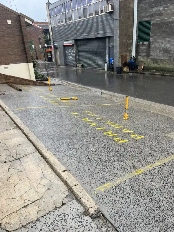 The same parking bays after pressure cleaning, with the aggregate concrete a clean, even grey